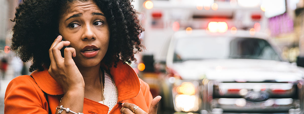 afro american woman calling 911 in New york city. concept about car accidents and emergency