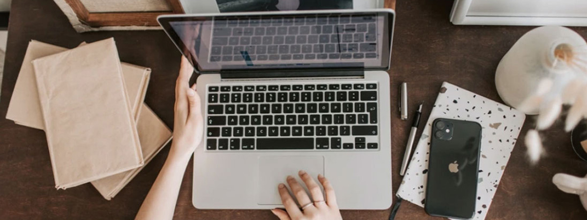 Birds eye view of a property manager working at a laptop 