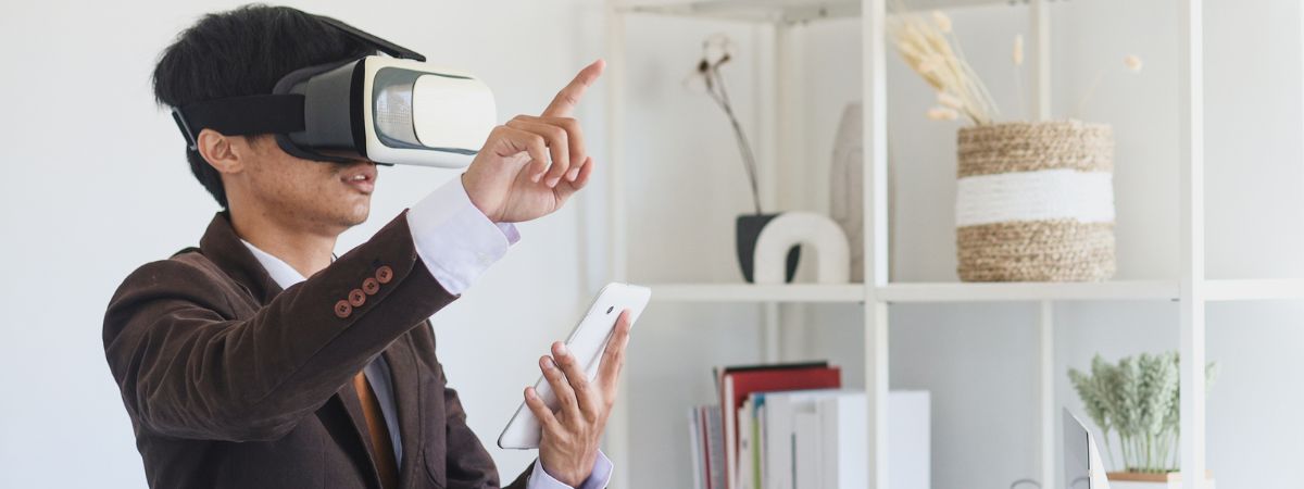 a man wearing virtual reality equipment works in digital property investmenr