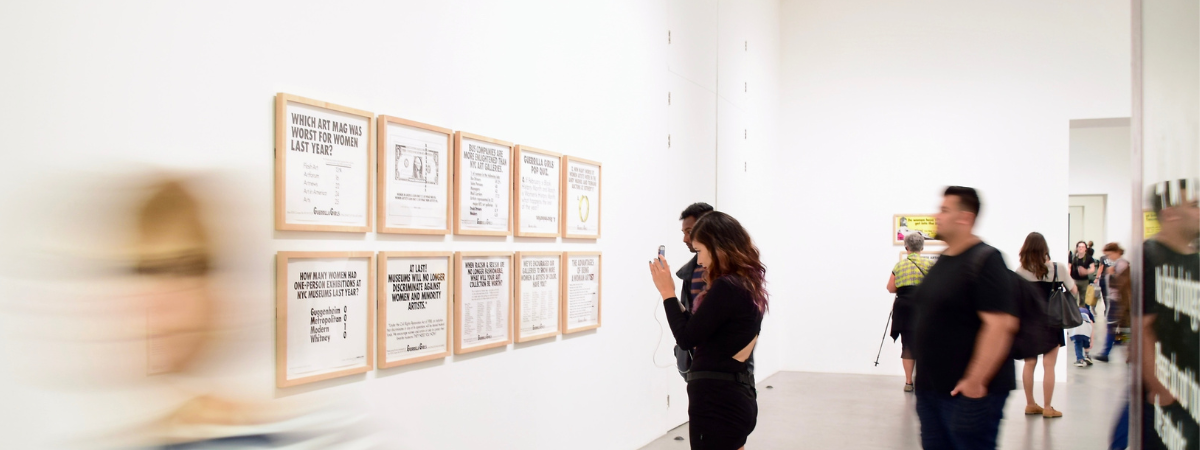 A woman takes a photo of an exhibition at the Saatchi gallery in London