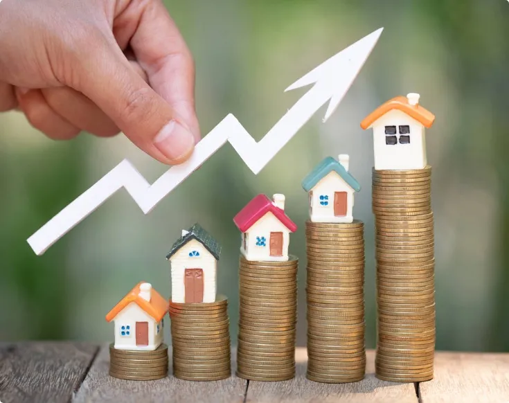 small houses sitting on coins to signify the property letting market in the UK