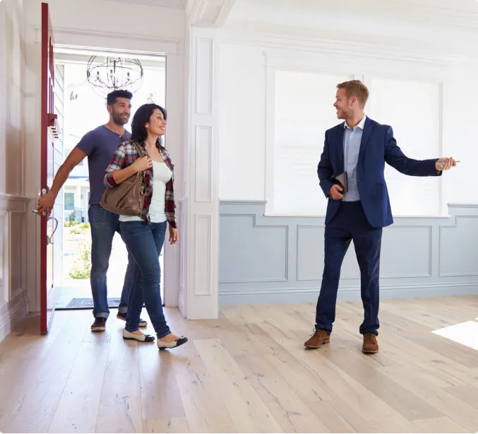 Letting agent showing tenants around a modern flat in London