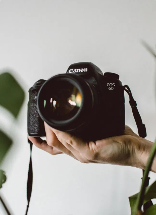 Someone holding up a DSLR camera