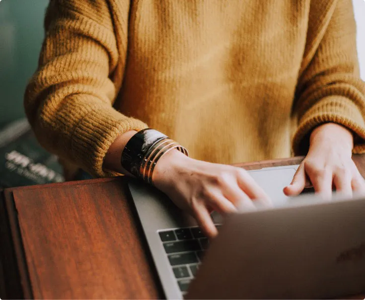 Person looking for a new home on their laptop