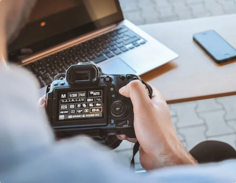 someone inspecting a DSLR camera