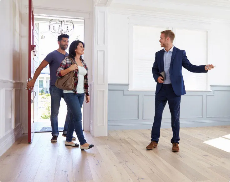 Letting agent showing tenants around a modern flat in London