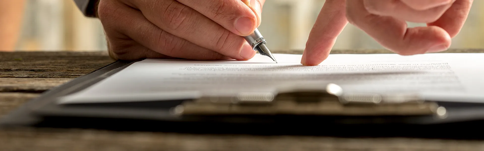 A person checking and signing the terms and conditions of a document